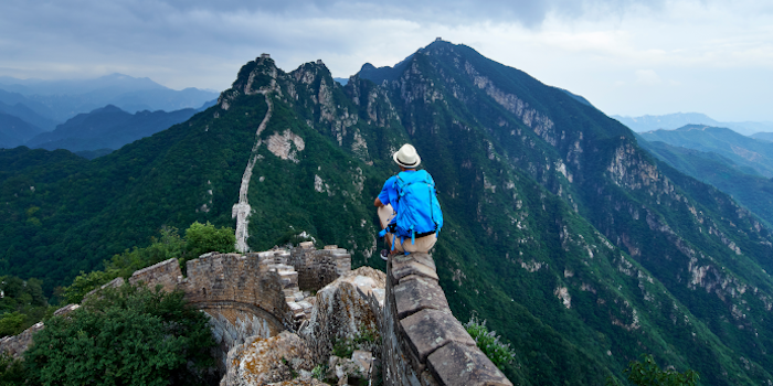 Man sitting at Great Wall of China