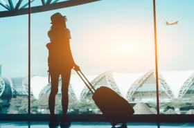 Woman looking out airport window